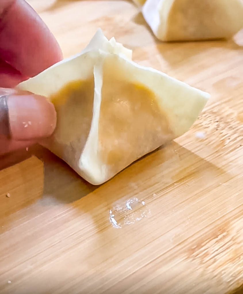 close up view of the shape of a buffalo chicken wonton