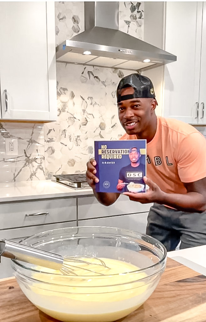 Dave holding a recipe book in front of banana pudding batter