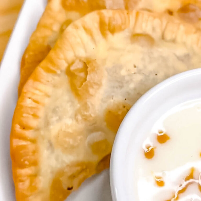 close up of caramel apple empanada and dipping sauce