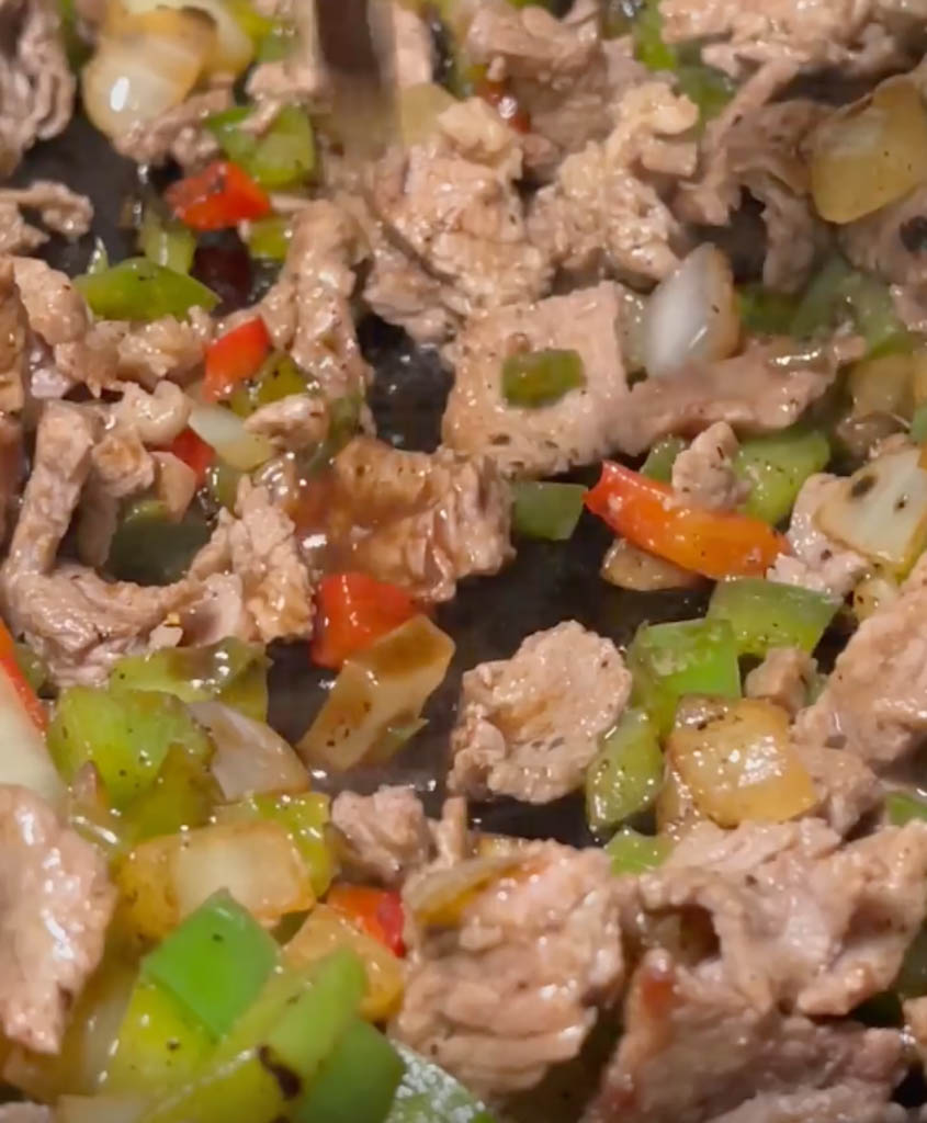 close up view of cheesesteak filling for egg rolls
