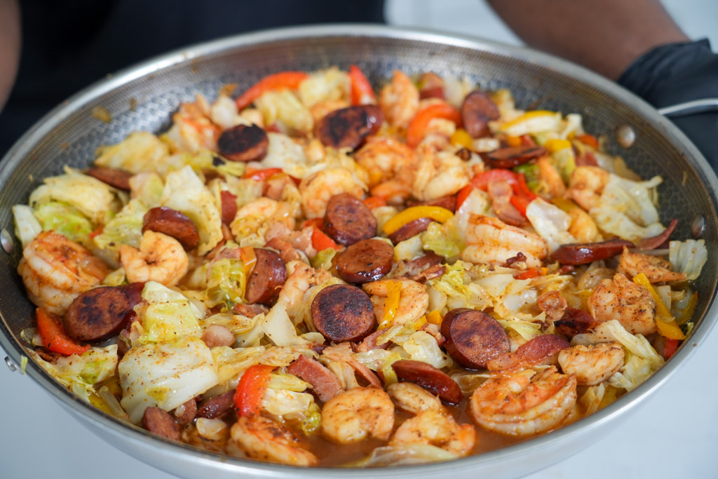 pot of southern fried cabbage with shrimp bacon and sausage