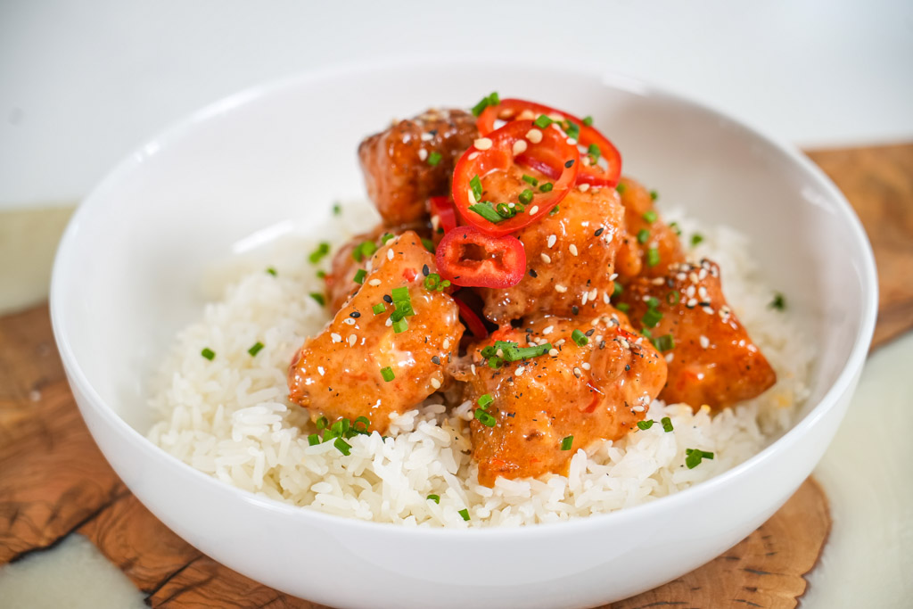 https://onestopchopllc.com/wp-content/uploads/2023/05/bang-bang-salmon-bites-over-rice.jpg