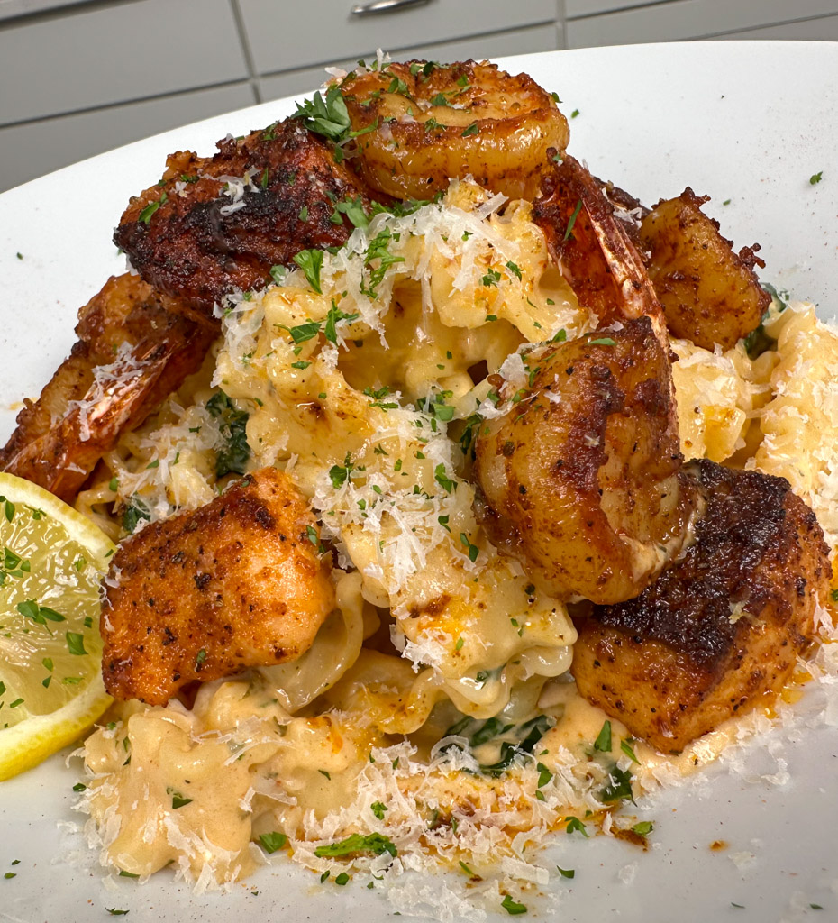 a plate of creamy cajun pasta with shrimp and salmon