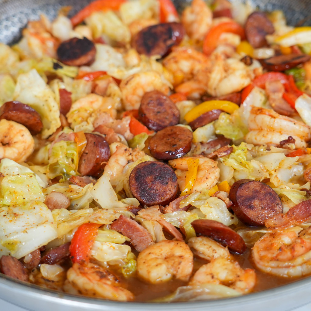 pot of southern fried cabbage with shrimp bacon and sausage