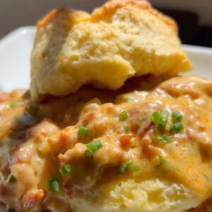 plate of homemade buttermilk biscuits with chorizo gravy on top