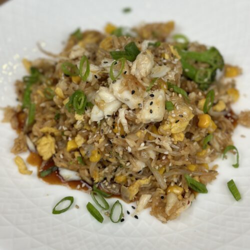 Completed crab fried rice dish presented on a plate ready to serve.