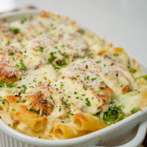 large casserole dish of baked chicken and broccoli pasta