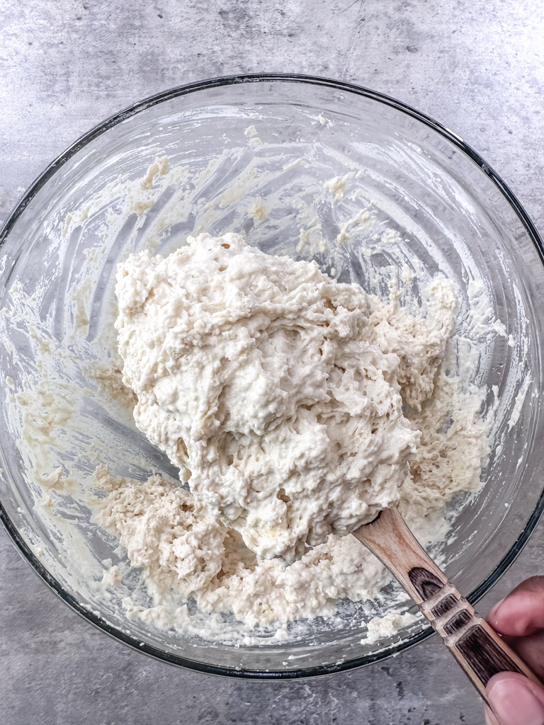 Stirring ingredients together to bring the biscuit dough together.
