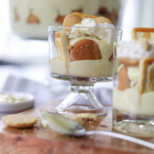 Banana Pudding in a glass topped with whipped cream on a counter