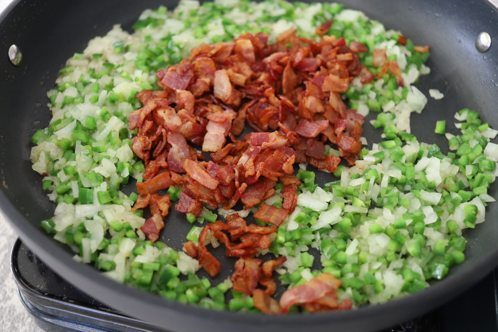 Bacon and onion in a frying pan.
