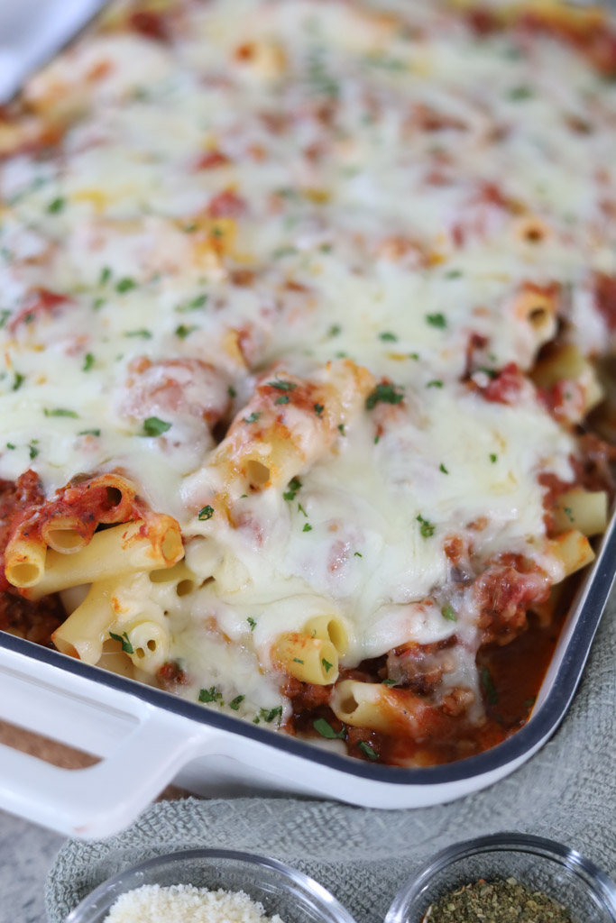 Baked Ziti in a casserole dish topped with parsley