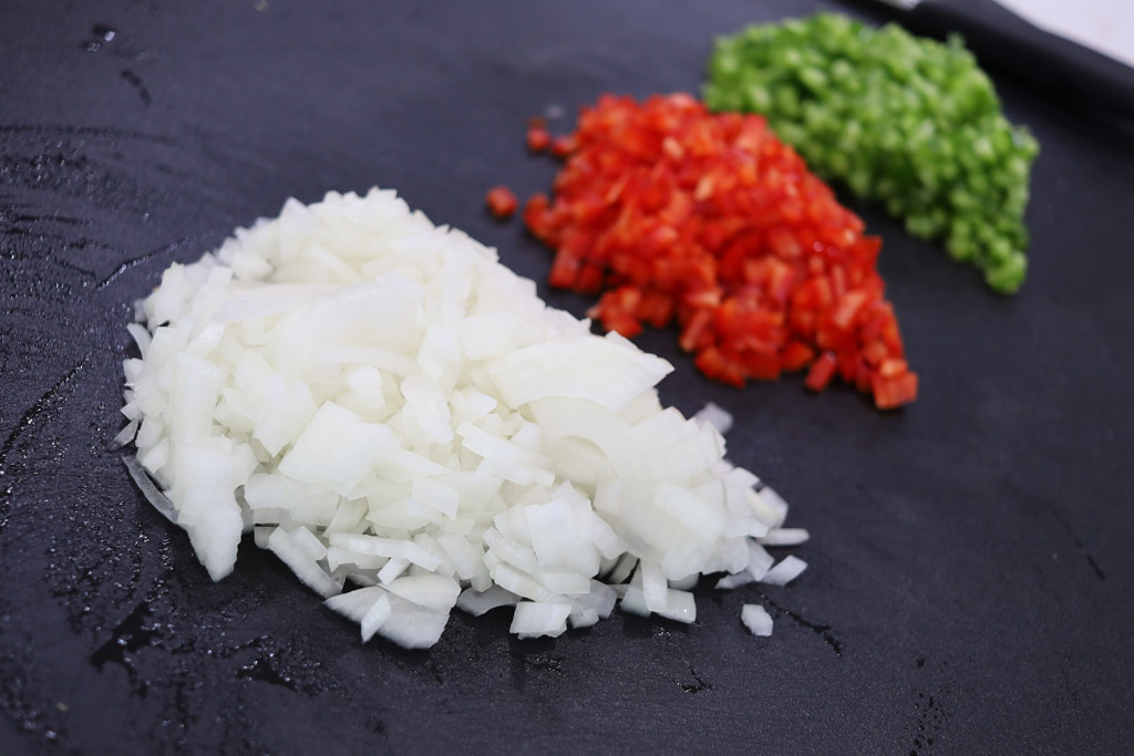 Chopped onions, red peppers, and green peppers.