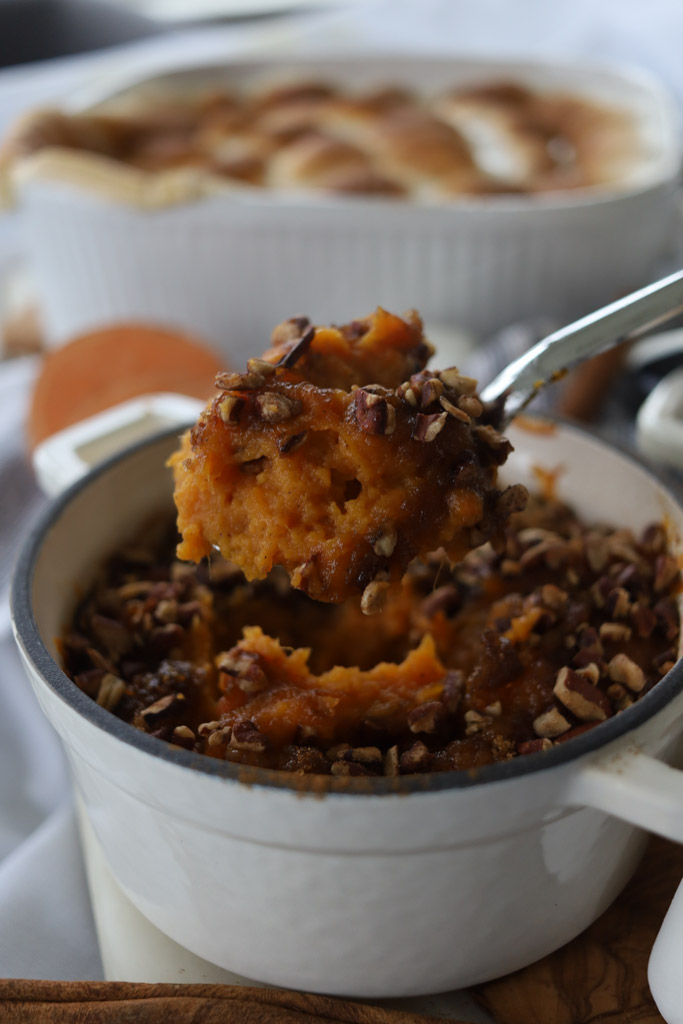 Sweet Potato Soufflé in a serving bowl being spooned out to show it close up.